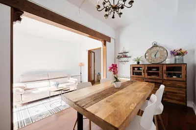 a living room with a wooden table and a couch at Apartamento en Caldes d'Estrac in Caldes d'Estrac