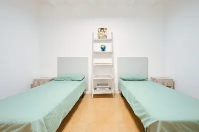 two beds sitting next to each other in a room at Apartamento en Caldes d'Estrac in Caldes d'Estrac