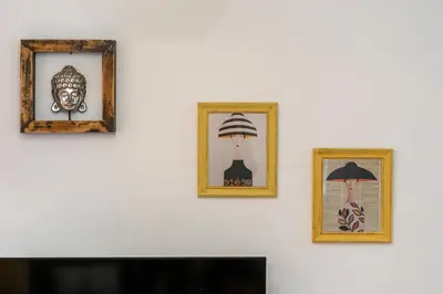 three framed pictures on a wall with a television at Whisper-Quiet 2BR Near Sagrada in Barcelona