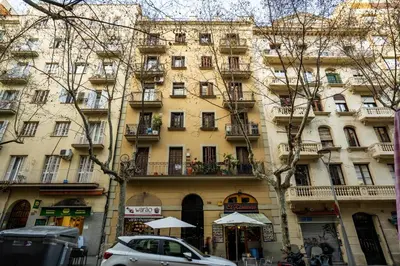 a tall building with cars parked in front of it at Whisper-Quiet 2BR Near Sagrada in Barcelona