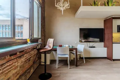a dining room with a table and chairs and a tv at Enjoybcn Plaza Catalunya Apt. in Barcelona