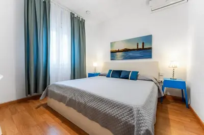 a bedroom with a bed and a large window at Mediterranean and connected in Sant Adria de Besos