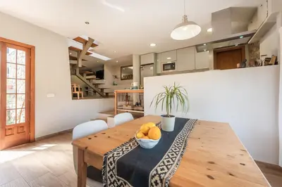 a dining room with a wooden table with fruit on it at Casa Olivella #7 by Happy Houses Barcelona in Olivella