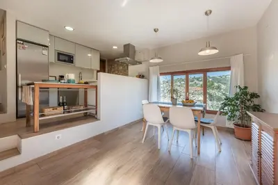 a kitchen and dining room with a table and chairs at Casa Olivella #7 by Happy Houses Barcelona in Olivella