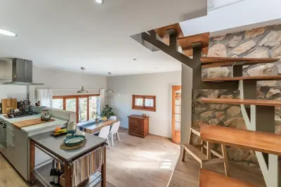 a kitchen and living room with a stone wall at Casa Olivella #7 by Happy Houses Barcelona in Olivella