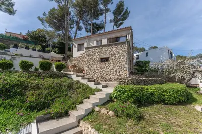 a stone house with stairs in front of a building at Casa Olivella #7 by Happy Houses Barcelona in Olivella