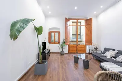 a living room with a couch and a table at Canela Homes BARCELONA MERCÈ in Barcelona