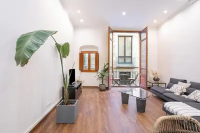 a living room with a couch and a table at Canela Homes BARCELONA MERCÈ in Barcelona