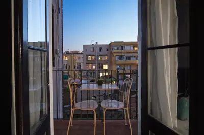 a view of a table and chairs from a balcony at Brummell Apartments Gracia in Barcelona