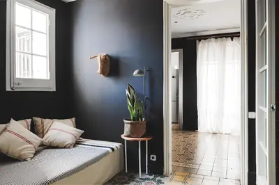 a bedroom with a bed and a plant on a table at Brummell Apartments Gracia in Barcelona