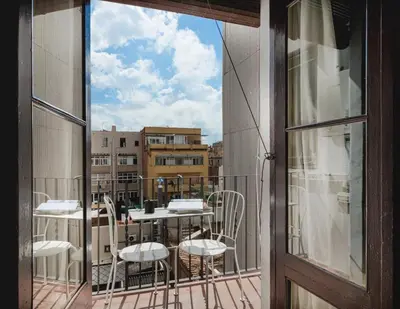 a balcony with a table and chairs and a window at Brummell Apartments Gracia in Barcelona
