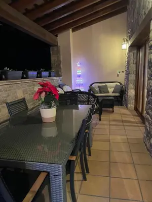 a dining room with tables and chairs and a couch at Cal correu Hort - Xida in Collsuspina