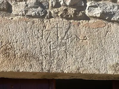 a stone wall with writing on the side of it at Cal correu Hort - Xida in Collsuspina