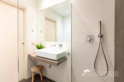 a bedroom with a bed and a desk with a lamp at Modern Apartment Lily close to beach with Com Pool and AC in Sitges