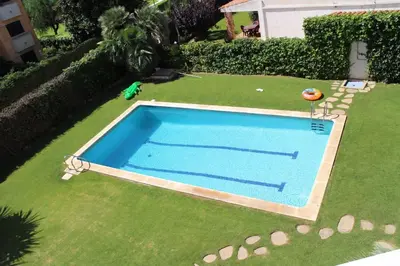 an overhead view of a swimming pool on a lawn at Modern Apartment Lily close to beach with Com Pool and AC in Sitges