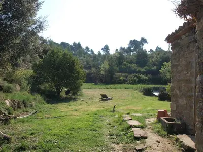 a yard with a bench in the middle of a field at Music room in Montserrat in Castellbell i Vilar