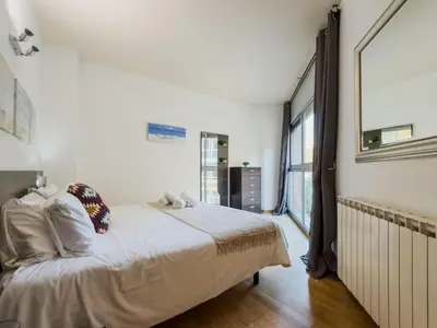 a bedroom with a bed and a large window at Bed BCN Vila Olímpica. in Barcelona