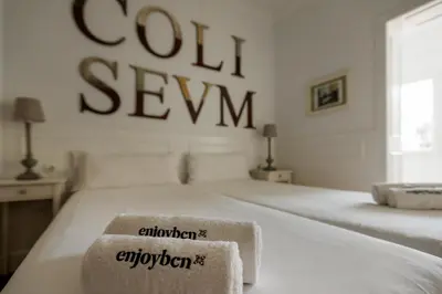 a white bed with a sign that says coil sew at Enjoybcn Coliseum Apartments in Barcelona