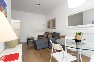 a living room with a glass table and a couch at Enjoybcn Coliseum Apartments in Barcelona