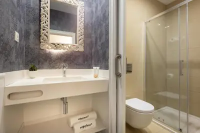 a bathroom with a sink and a toilet and a shower at Enjoybcn Coliseum Apartments in Barcelona