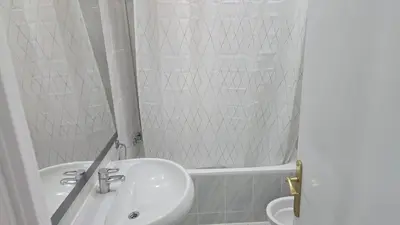 a white bathroom with a sink and a tub at A 10 de sagrada familia minutos caminando in Barcelona