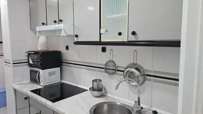 a kitchen with a sink and a microwave at A 10 de sagrada familia minutos caminando in Barcelona