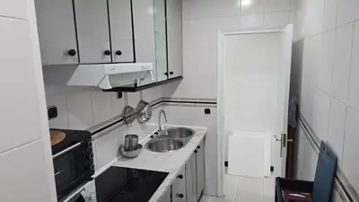a small kitchen with a sink and a stove at A 10 de sagrada familia minutos caminando in Barcelona