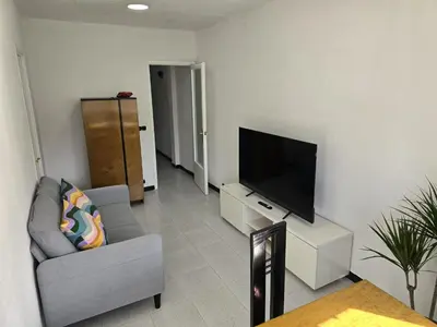 a living room with a flat screen tv on a wall at A 10 de sagrada familia minutos caminando in Barcelona