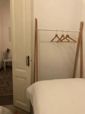 a room with a bed and a closet with hangers at 1 Casual Apartments in Barcelona