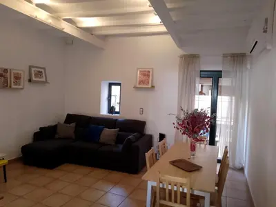 a living room with a couch and a table at Charming traditional family townhouse in Calella in Calella
