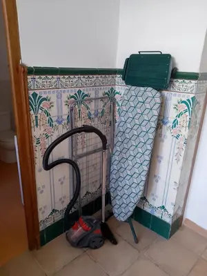 a room with a cleaning mop next to a wall at Charming traditional family townhouse in Calella in Calella