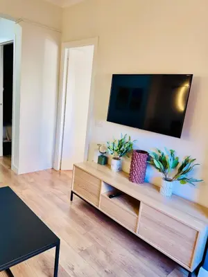 a living room with a flat screen tv on the wall at Apartamento Lauda 2 in Hospitalet de Llobregat