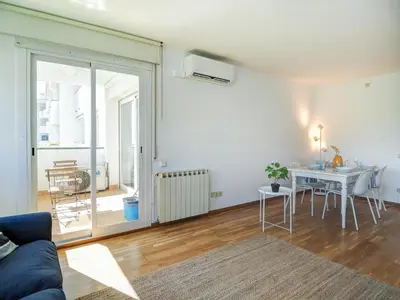a living room with a couch and a table at Viva Palms by Hello Homes Sitges in Sitges