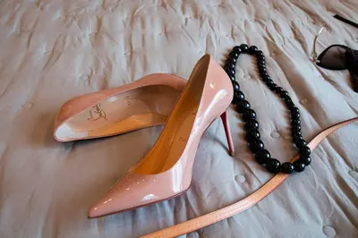 a pair of shoes and a necklace on a bed at Perfect Romantic Getaway Cozy Retreat with Jacuzzi in Barcelona