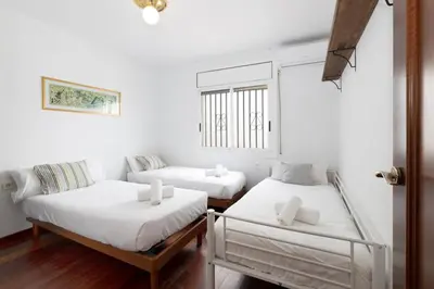 a white room with two beds and a couch at Exclusive Villa with Private Pool in Sitges in Sitges