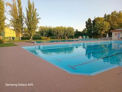 a patio with a table and chairs and a tree at House for 8-14 people 25 min from Barcelona, Montserrat, Sitges, Penedes, Sant Cugat in Abrera