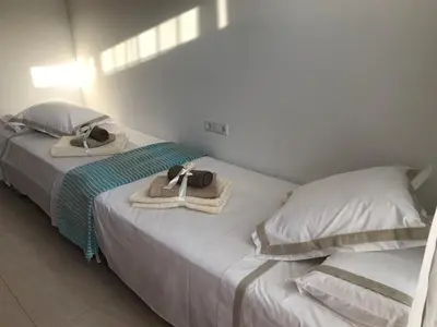 two beds with towels and hats on top of them at House for 8-14 people 25 min from Barcelona, Montserrat, Sitges, Penedes, Sant Cugat in Abrera