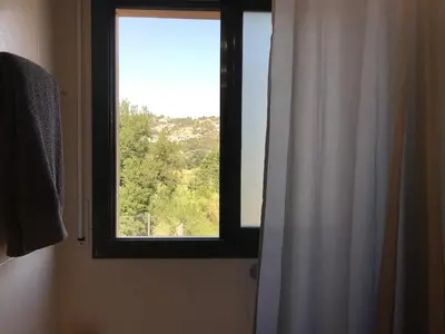 a window in a bathroom with a shower curtain at House for 8-14 people 25 min from Barcelona, Montserrat, Sitges, Penedes, Sant Cugat in Abrera