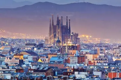 a view of a city at night with a cathedral at Romantic in Trendy Gracia in Barcelona