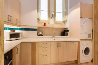a kitchen with a sink and a microwave at Romantic in Trendy Gracia in Barcelona