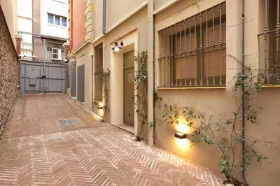 an empty alley with a building and a window at Romantic in Trendy Gracia in Barcelona