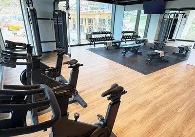 a gym with treadmills and benches in a room at aparto Diagonal Suites in Esplugues de Llobregat
