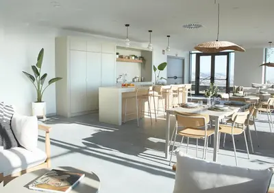 a kitchen and living room with a table and chairs at aparto Diagonal Suites in Esplugues de Llobregat