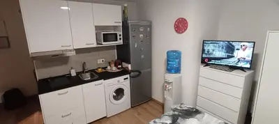 a small kitchen with a refrigerator and a microwave at Studio B in Santa Coloma de Gramanet