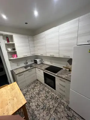 a kitchen with white cabinets and a white refrigerator at HABITACIÓN barcelona in Barcelona