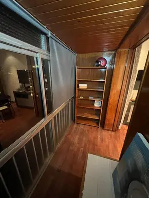 an empty room with a balcony with a wooden floor at HABITACIÓN barcelona in Barcelona