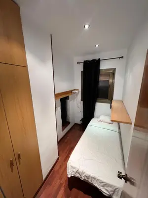 a small room with a bed and a closet at HABITACIÓN barcelona in Barcelona