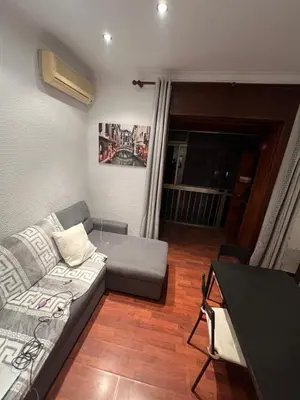 a living room with a couch and a table at HABITACIÓN barcelona in Barcelona