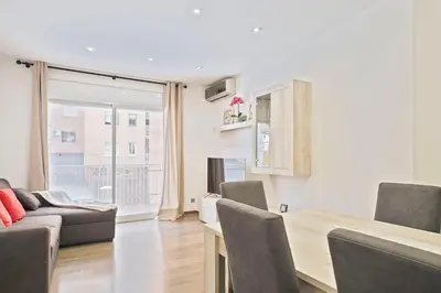 a living room with a table and chairs and a couch at Dialez Holidays - Sant Nicasi in Gavà