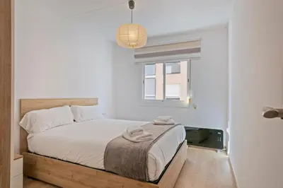 a bedroom with a bed with towels on it at Dialez Holidays - Colomeres in Gavà
